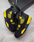 Black & yellow Jordan 4’s