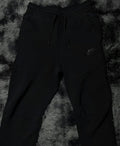 Black Nike tech pants